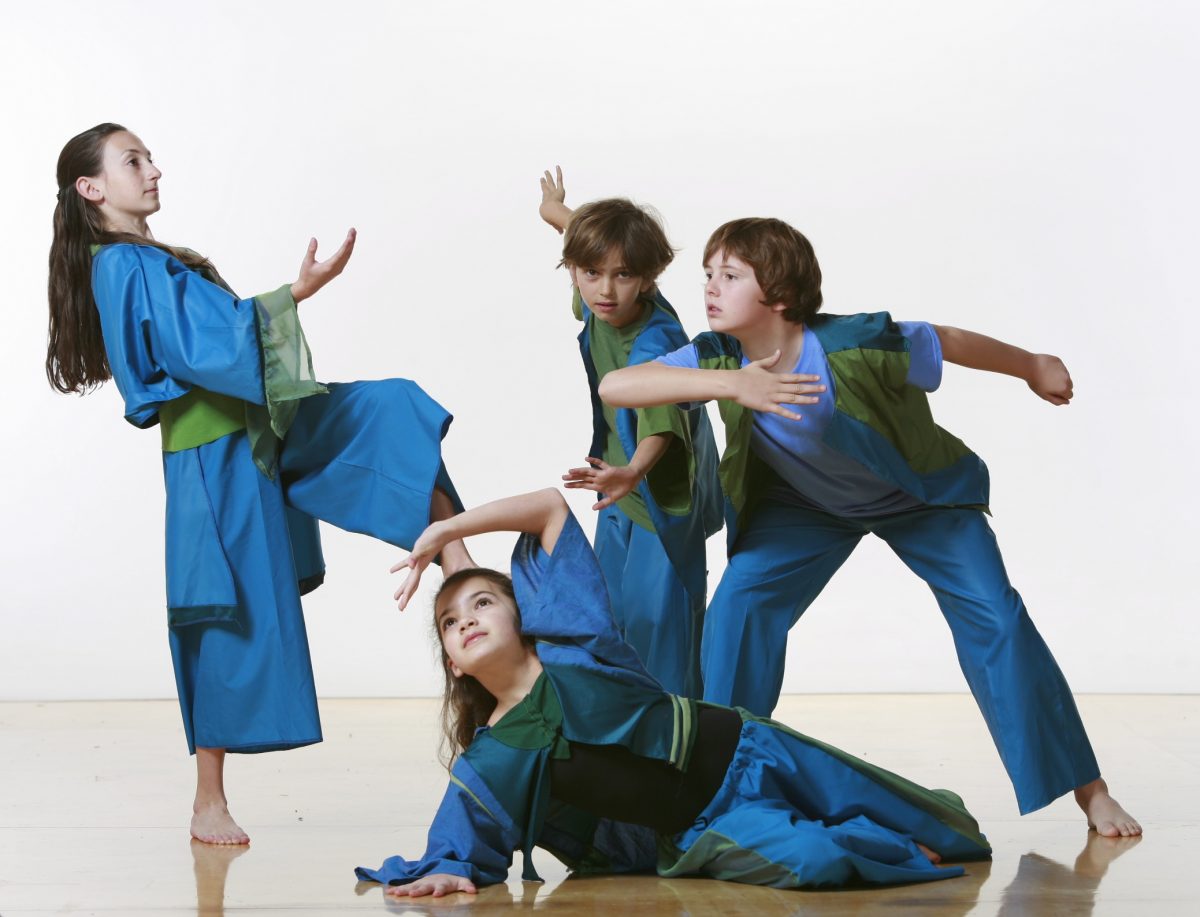 4 dancers in blue and green costumes in various poses