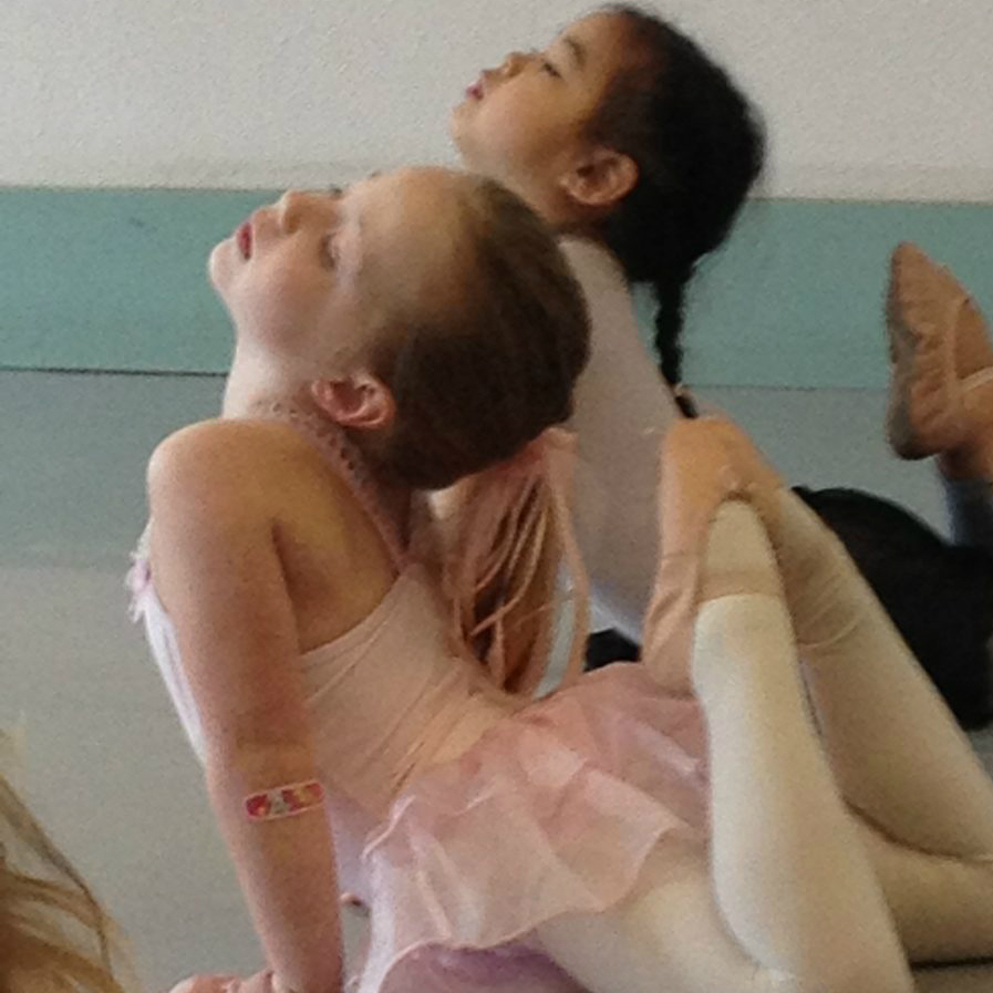 Two young dancers stretch during serendipity