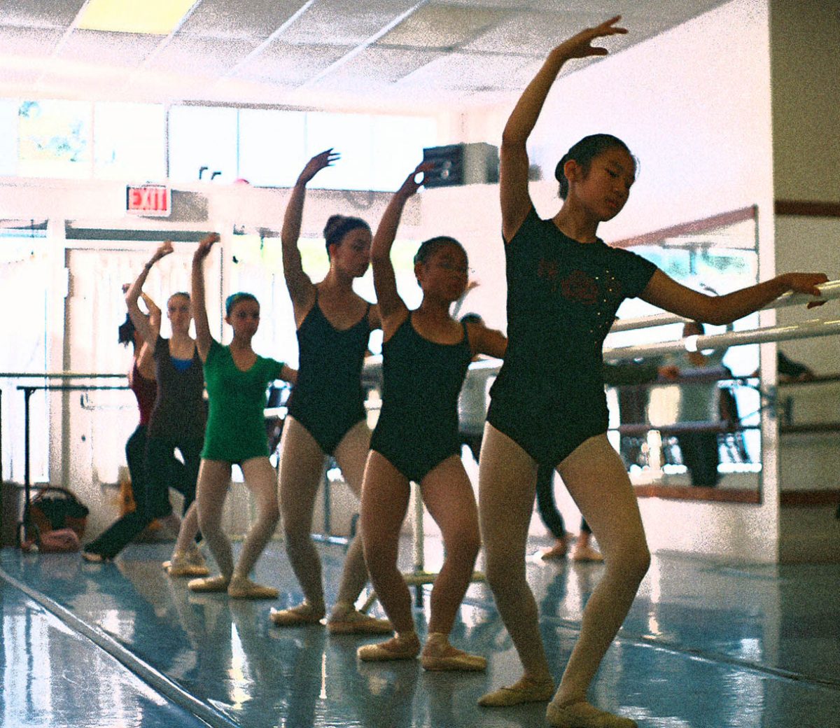 Dancers working at the barre during class