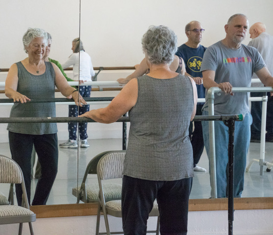 During Dance for PD, dancers stand at the barre.