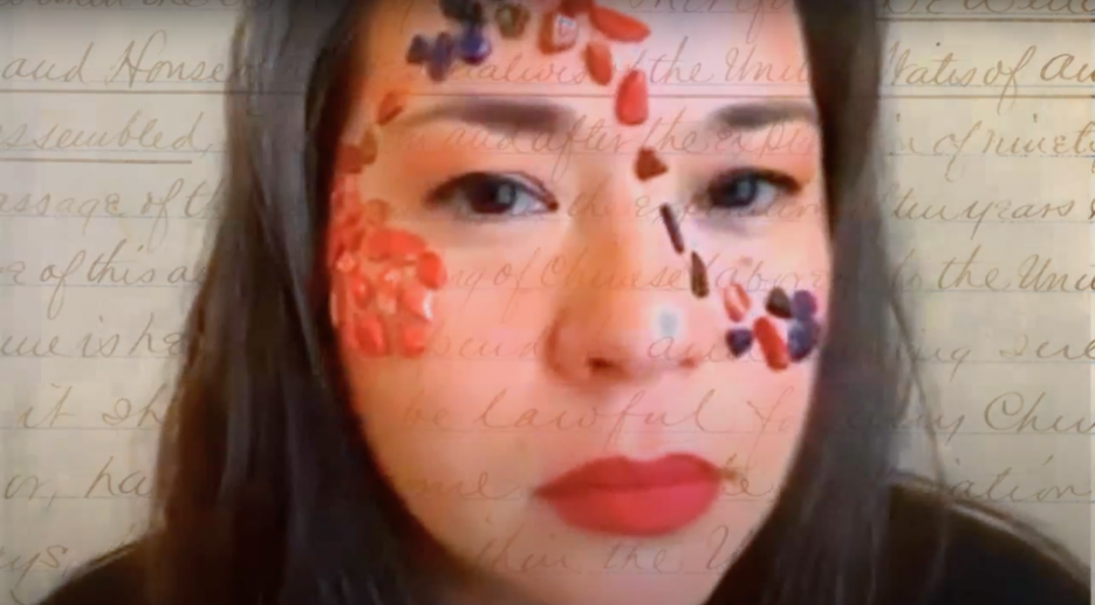 A closeup photo of an Asian woman with colorful gems on her face. Overlayed is cursive handwriting, but the text is not readable.