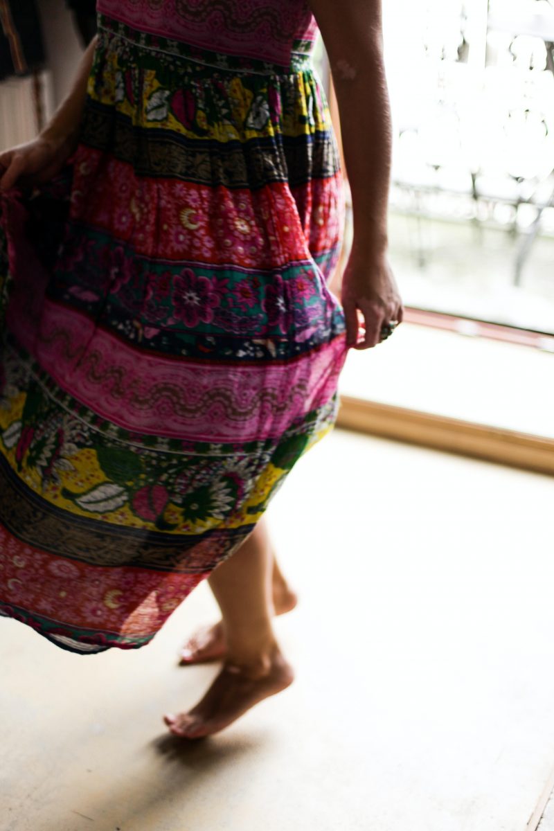 Stock photo of a person in a flowy skirt mid twirl.