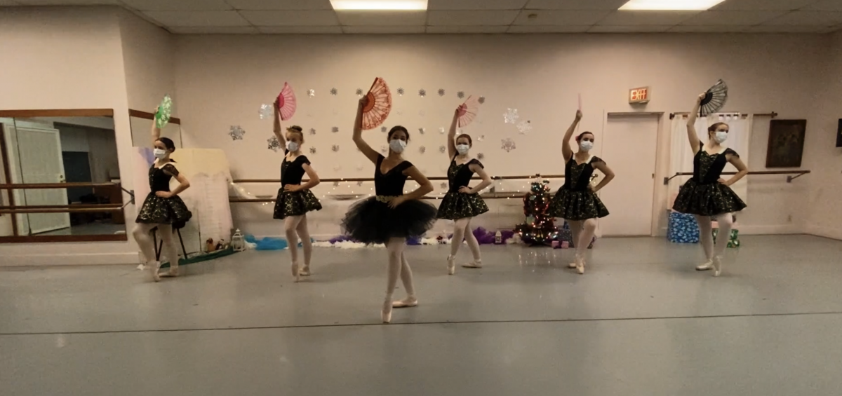 A screenshot of 6 dancers in costumes, masks, and holding fans during an in-studio Nutcracker performance.