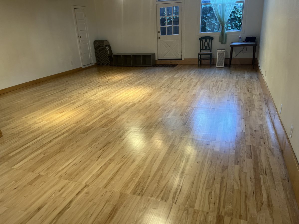 Studio 3 has wood floors, no mirrors, and a door on both ends of the studio.